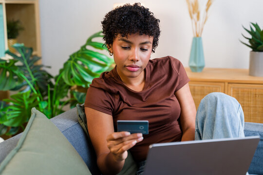 African American woman making online shopping payment with credit card
