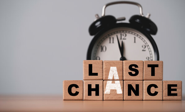 Last chance and deadline concept in front of vintage black alarm clock near midnight symbolizing for urgency final opportunity, limited time offers and time running out in business.