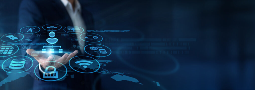 IT administrator carefully monitoring servers, holding handheld devices for Network Administration throughout the Global network hub. Managing active traffic easily. Ensuring uptime now.