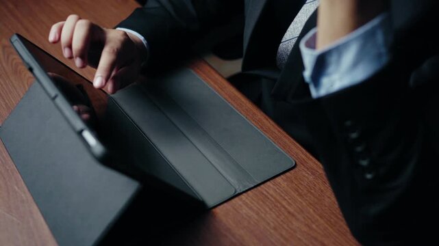 Businessman interacting with tablet, financial analysis, professional workflow, corporate strategy, digital communication, touch screen interface on dark background 4k video