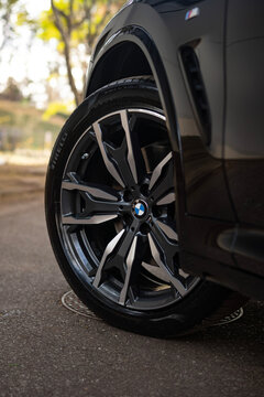 Black BMW X4 Luxury SUV Alloy Wheel Close Up Detail Parked On Asphalt Road Outdoors