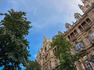Ornate Historic Architecture with Green Trees and Blue Sky — Antwerp, Belgium © Bjorn B