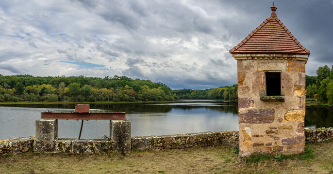 Thunderstorm over Troncais lake (Allier, France) ; out of service water management structures in the foreground 