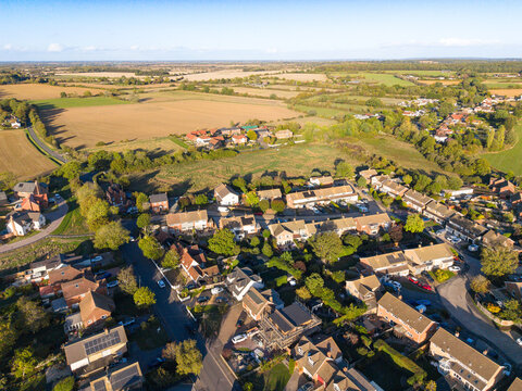 Drone view of the large rural village of Blackmore, Essex, UK. Showing the village to the bottom and the expansive arable fields towards the horizon.