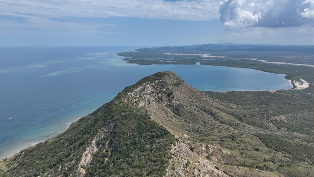 Aerial view of El Morro de Montecristi, a limestone headland rising above the turquoise Caribbean Sea, with coastal cliffs in Monte Cristi, Monte Cristi Province, Dominican Republic.