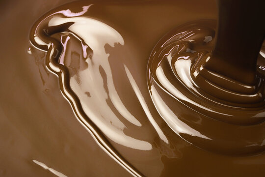 pouring hot chocolate, sweet dessert. liquid chocolate background