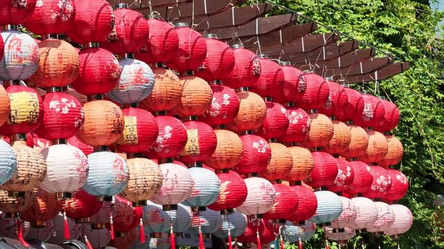 Rows of lanterns sway in the gentle breeze.