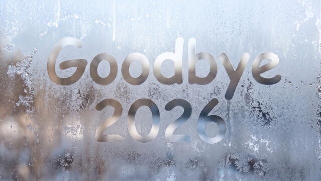 Goodbye 2026 written on a frosty window pane representing the end of