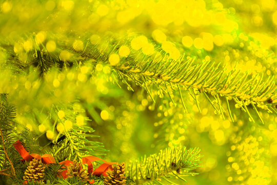Golden Christmas Greeting Card with Pinecones and Sparkling Bokeh Lights Background