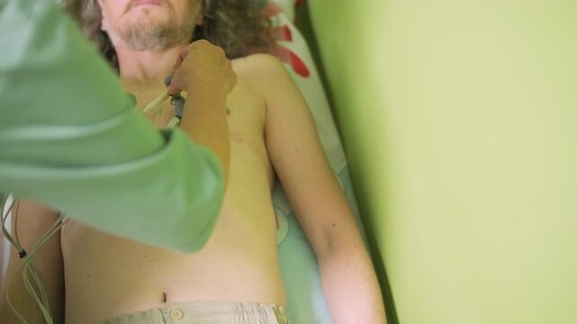 ECG Suction Cup Electrodes on Male Patient's Chest During Cardio Exam