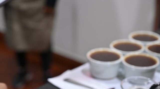 Barista writing coffee cupping score sheet