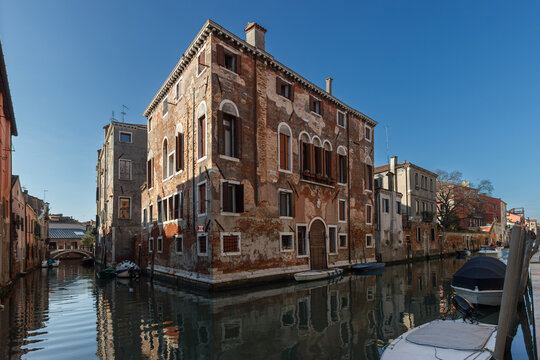Historic residential building along canal in Fondamenta de la Misericordia in Cannaregio district, Venice, Italy