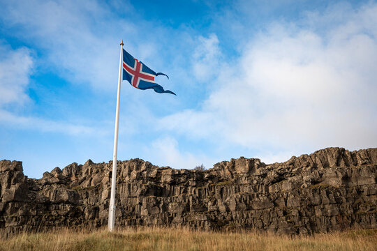Icelandic flag flying at the L&ouml;gberg (Law Rock) in Almannagj&aacute; gorge in &THORN;ingvellir National Park, south west Iceland, a key stop on the Golden Circle Route