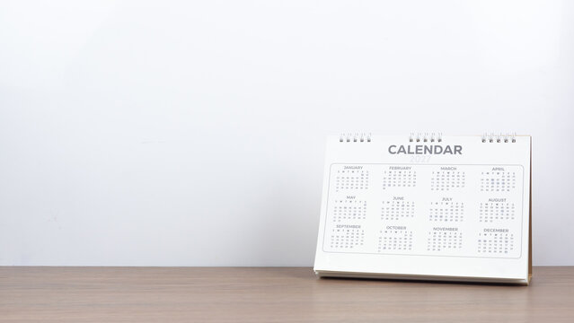 Calendar year 2027 schedule on wood table white background.
2027 calendar planning appointment meeting concept. copy space.