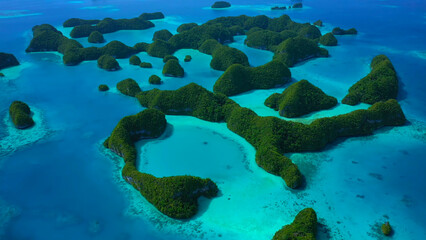 Drone aerial view photo of tropical paradise Seventy Islands of Palau in Pacific Ocean. Beautiful photography with palm trees, coral reef, azure ocean.  © TKalinovskaya