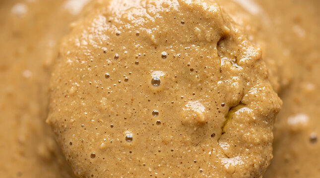 Close up of thick creamy nut butter with tiny bubbles, macro food photography