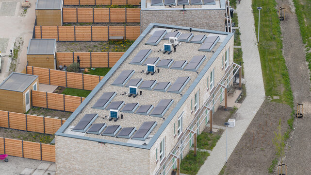 Aerial view of rooftop heat pumps on modern residential housing