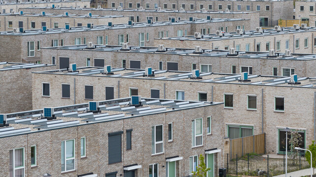 Aerial view of rooftop heat pumps on modern residential housing