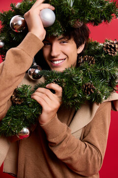 Happy man celebrating the holiday spirit with cozy elegance in a festive studio