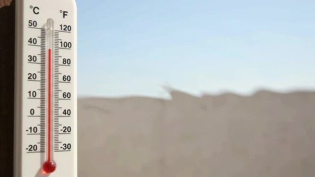 Video footage showing an outdoor thermometer indicating dangerously high temperatures, reflecting severe summer heat and the effects of extreme weather conditions on the environment