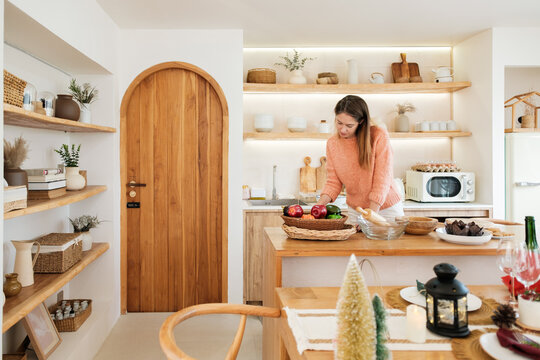 Woman Preparing Fresh Ingredients in Cozy Modern Home Kitchen