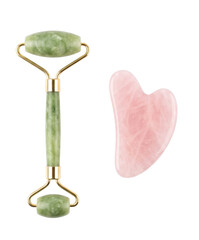 Green jade facial roller and pink gua sha stone isolated on a black background for skincare © Vova7