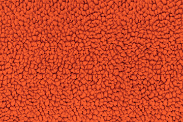 A full-frame, detailed close-up shot of soft bright orange sherpa fleece fabric, showing a fuzzy, curly teddy bear texture from a top-down view. Concept of warmth, comfort, cozy textile © DariaR