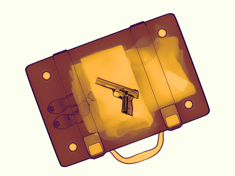 Gun Placed Inside a Suitcase on a Plain Background