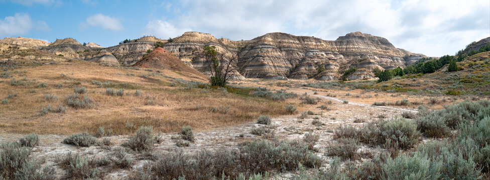 Panorama of the hiking trail leading into the canyon below clay buttes at Theodore Roosevelt National Park, North Dakota, USA