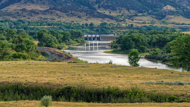 Panorama of the Yellowtail Afterbay Dam with its lights reflected in the river at dusk in Fort Smith, Montana, USA