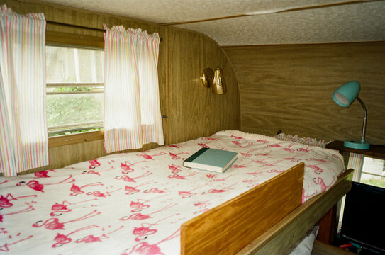 Vintage RV interior nobody bedroom with book