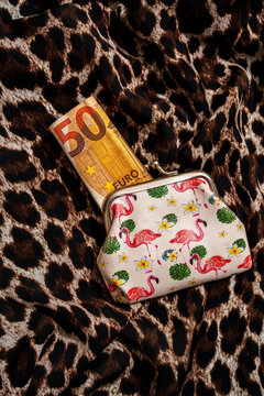 Coin purse with flamingo pattern and folded 50 euro banknote