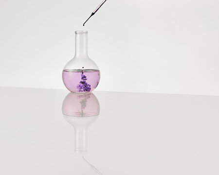 A round bottom laboratory flask with purple liquid