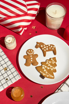 Christmas Table With Gingerbread Cookies, Candles and Wrapped Gifts