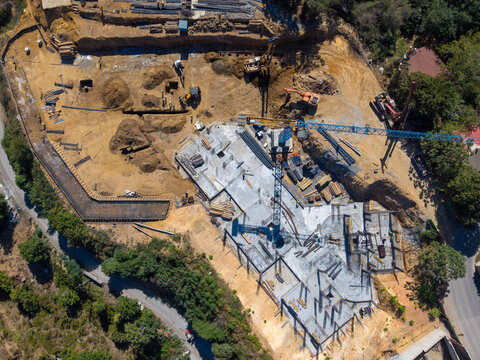 Aerial View Of Construction Site With Tower Crane And Machinery