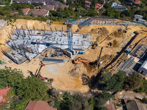 Aerial View Of Construction Site With Tower Crane And Machinery