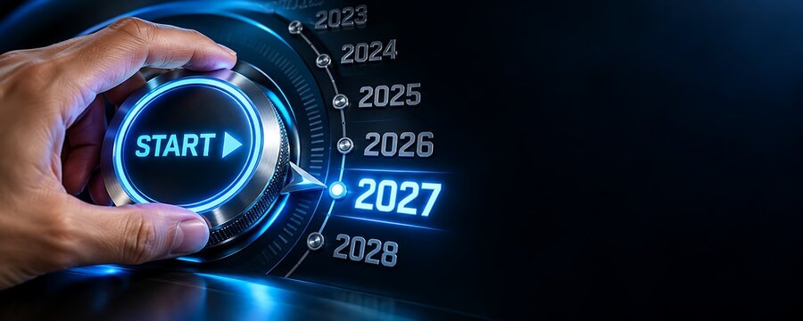 Human hand turning glowing metallic dashboard dial pointing precisely towards the glowing futuristic year twenty twenty seven typography against dark abstract background