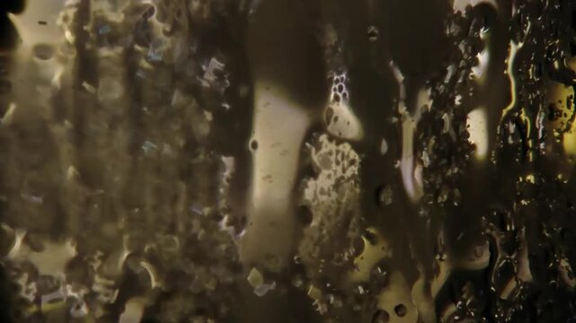 Dynamic abstract texture of random irregular rain drops covering a dark wet surface useful for blending modes visual effects and moody cinematic overlay Background