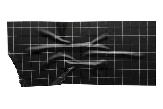 Black grid tape wrinkled on dark surface