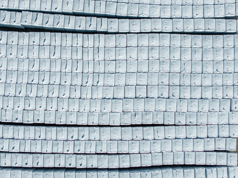 Aerial view of white-wrapped peat bales neatly stacked in rows at the B-Peat processing facility in Krimulda Parish, Sigulda Municipality, Latvia.