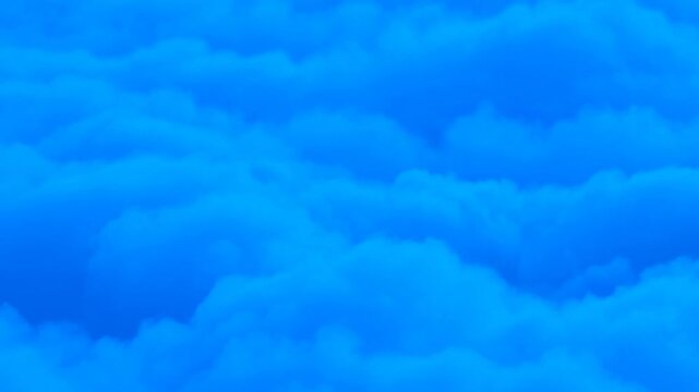 Blue cloud layers drift and reshape across a bright open sky in shifting formations