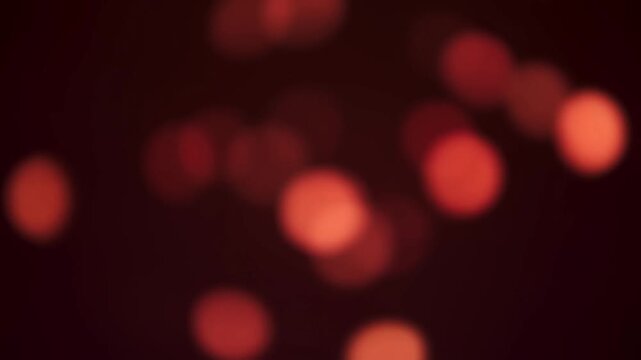 Amber bokeh lights softly fluctuate against a dark, defocused background