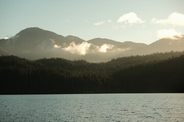 Naklejka premium Layered Misty Mountains Over Water