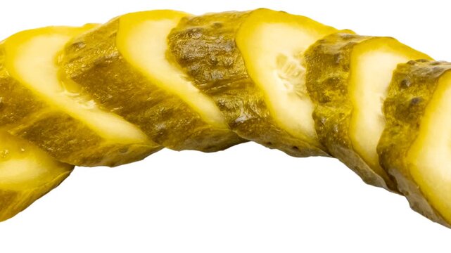 Four slices of greenish-yellow pickled cucumber arranged in a diagonal line. Visible seeds and textured skin with a wet, glossy surface.