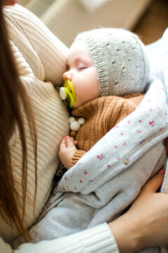 Happy family with a baby celebrating Christmas at home, enjoying cozy holiday moments together near a decorated Christmas tree in a warm festive atmosphere