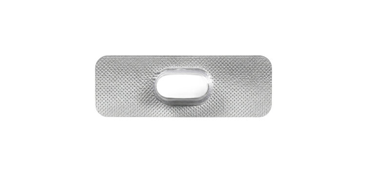 Single white oval pill in a silver blister pack, isolated on a clean white background, viewed from directly above