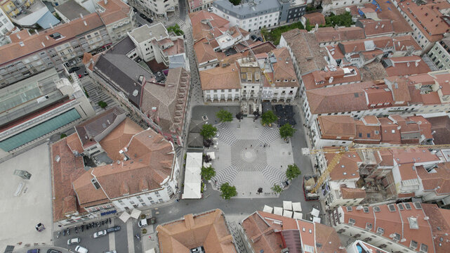 Aerial view of the historic Praca Rodrigues Lobo in Leiria, featuring its patterned stone pavement, traditional buildings, and trees, Leiria, Leiria District, Portugal.