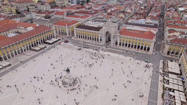 Aerial view of Praca do Comercio featuring the triumphal arch, equestrian statue, and expansive paved square surrounded by historic yellow buildings in Lisbon, Lisbon, Portugal.