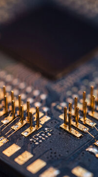 Macro view of gold circuit board pins and electronic components. Artificial intelligence hardware and cybersecurity technology. Semiconductor engineering, data processing and computer