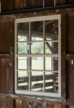 Rustic barn window with view of green fields, rural architecture and countryside living concept, weathered wood frame and vintage farmhouse interior
